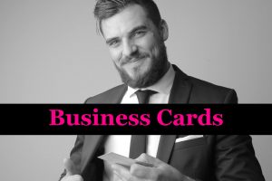 Smiling business man holding his business cards